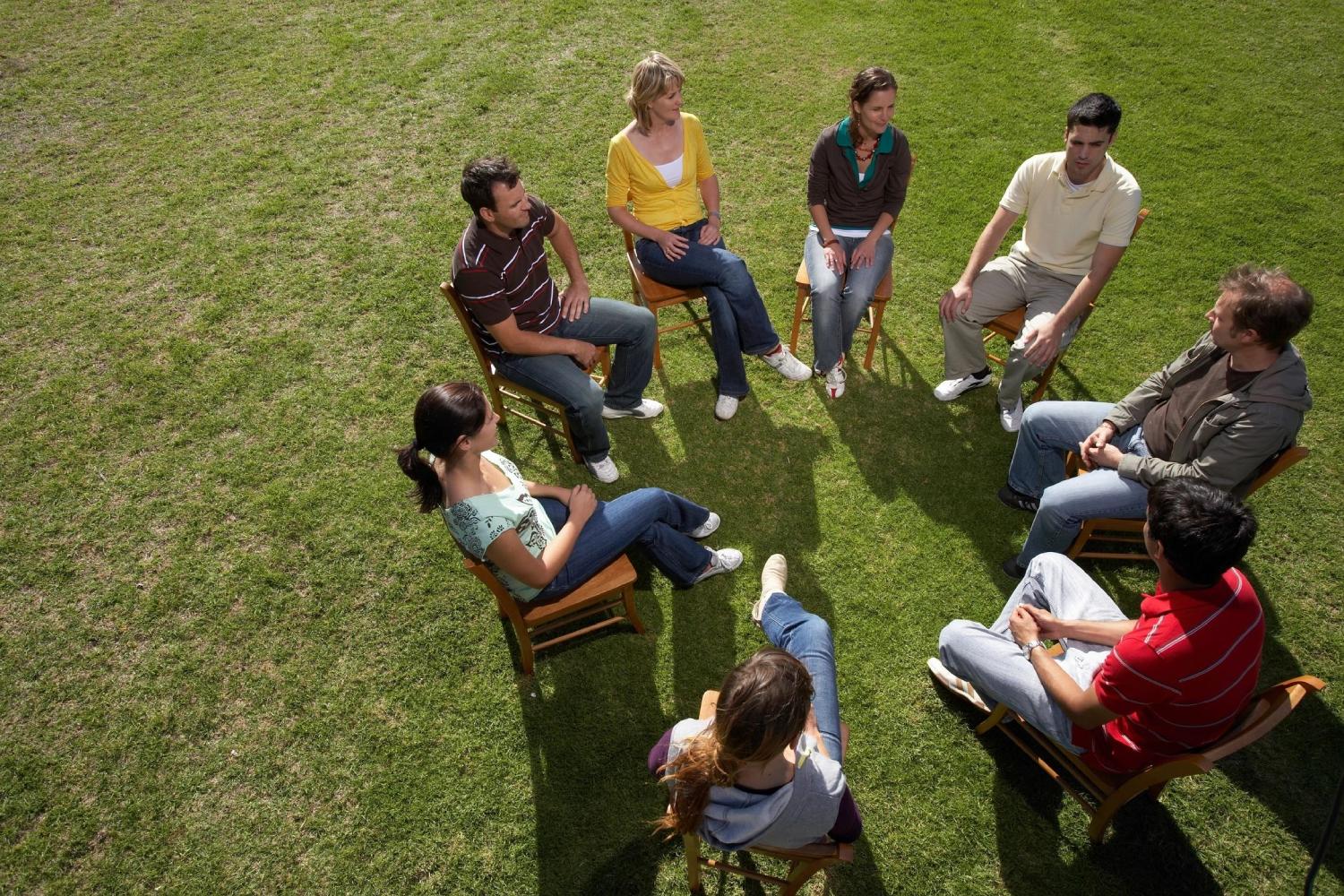 Group of People talking While Sitting in Circular Shape